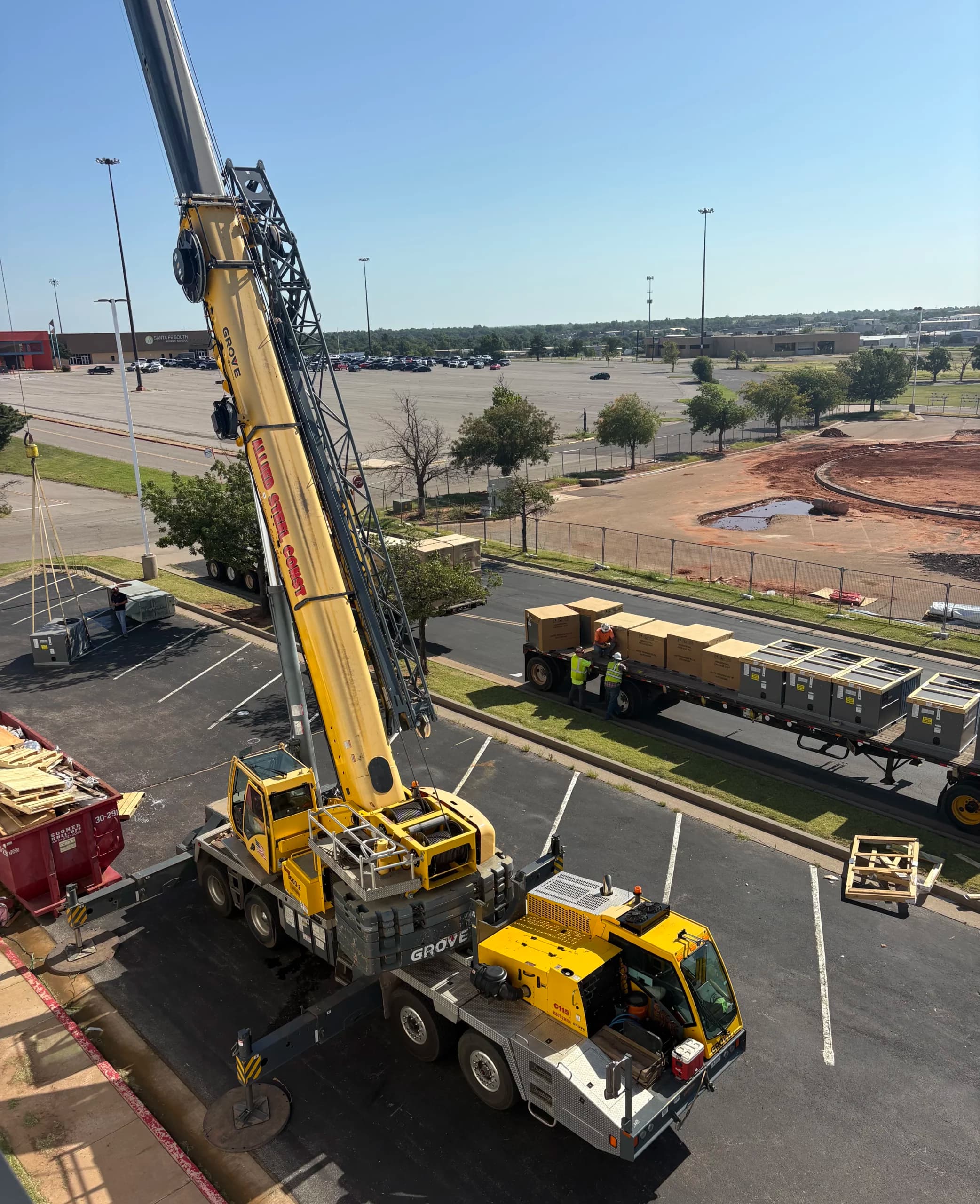Crane setting a new rooftop unit on an Oklahoma commercial building