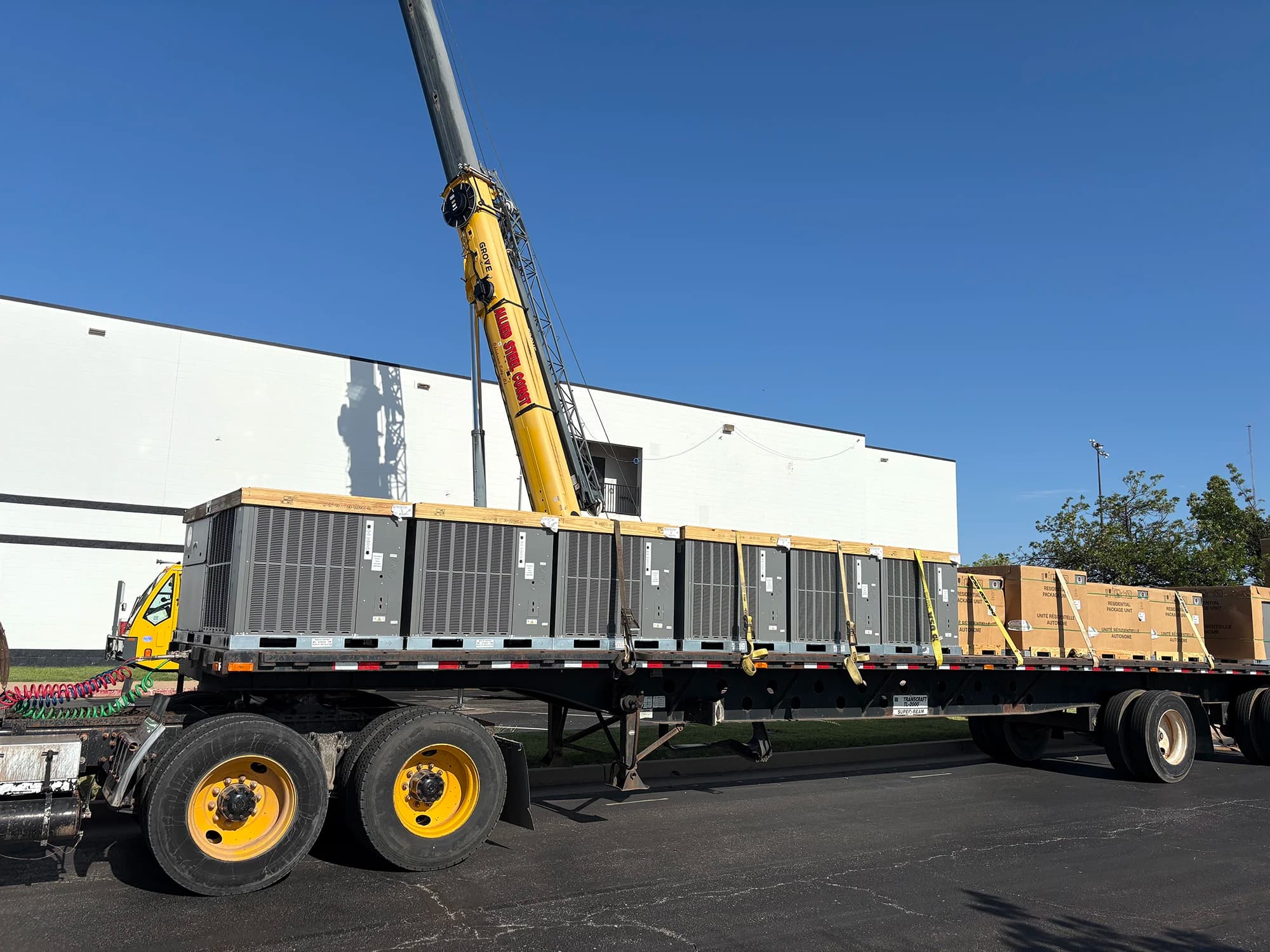 Flatbed delivering commercial HVAC units to a job site