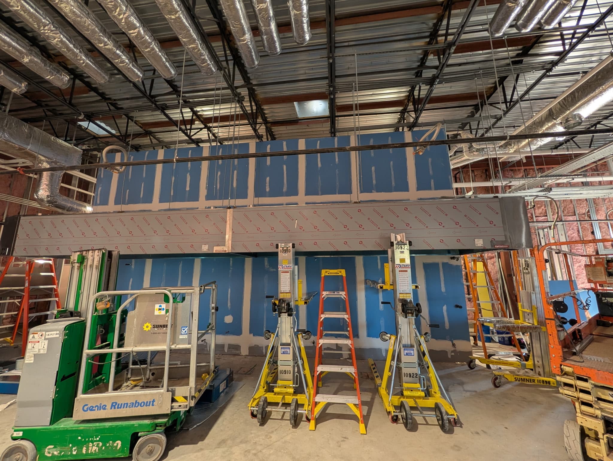 Insulated ductwork being installed in a commercial build-out