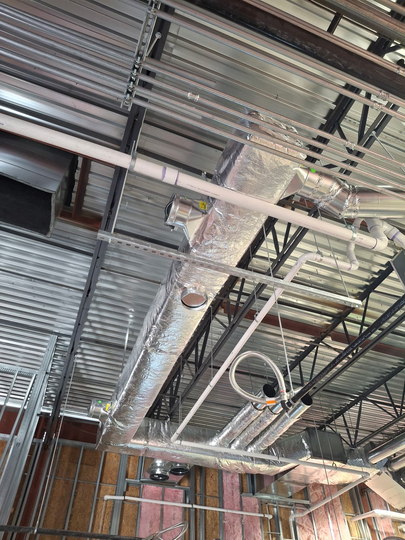 Insulated round duct and piping in a commercial ceiling
