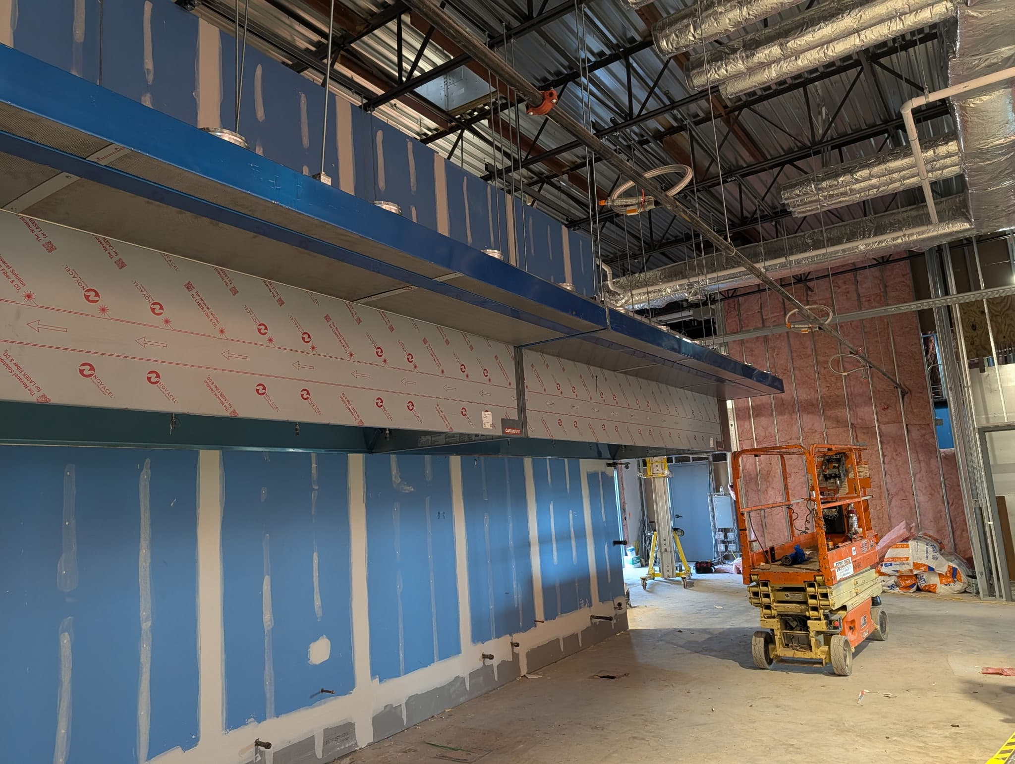 Commercial kitchen exhaust hood being installed in a new build-out