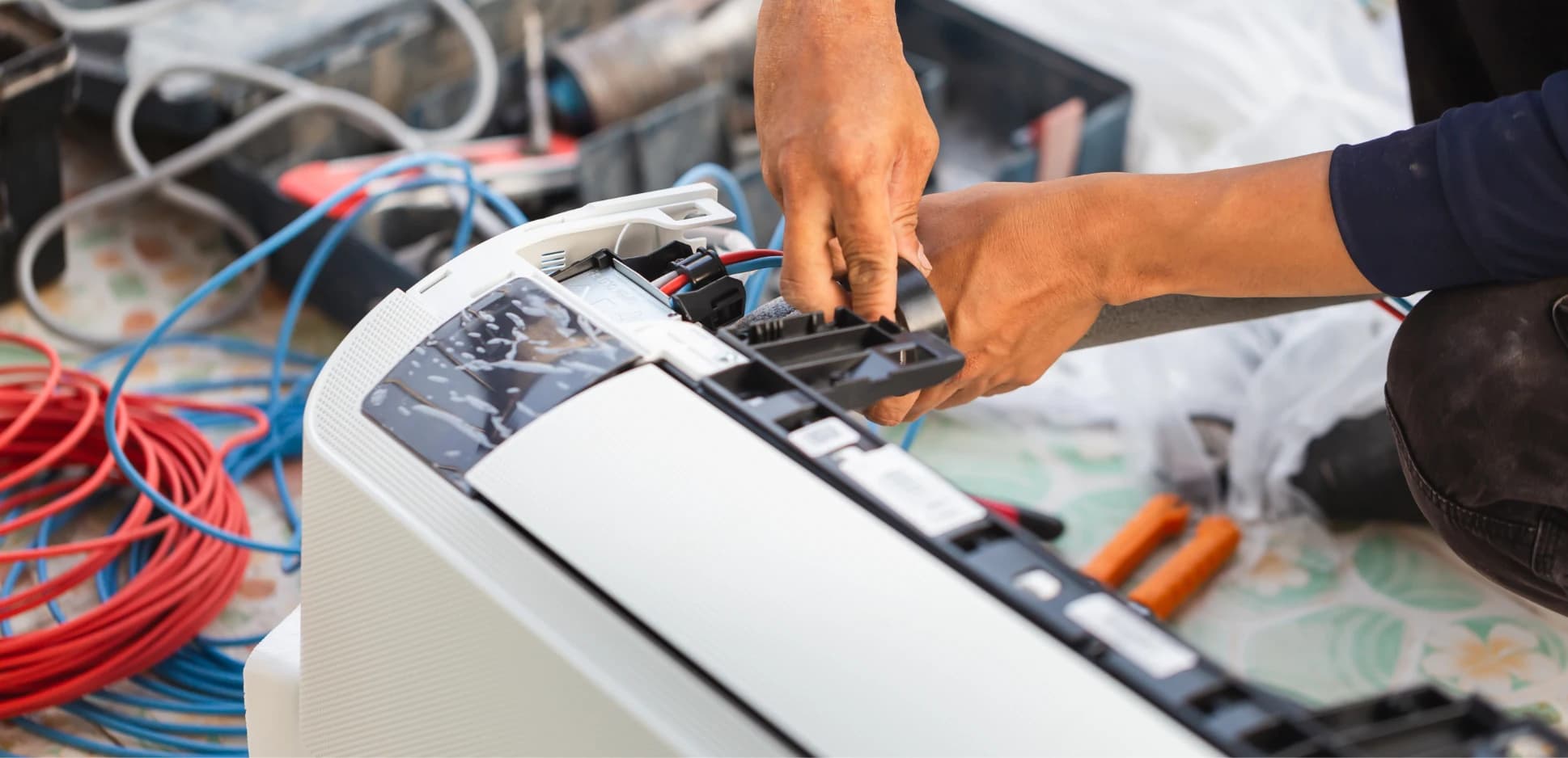 Technician wiring a ductless indoor unit