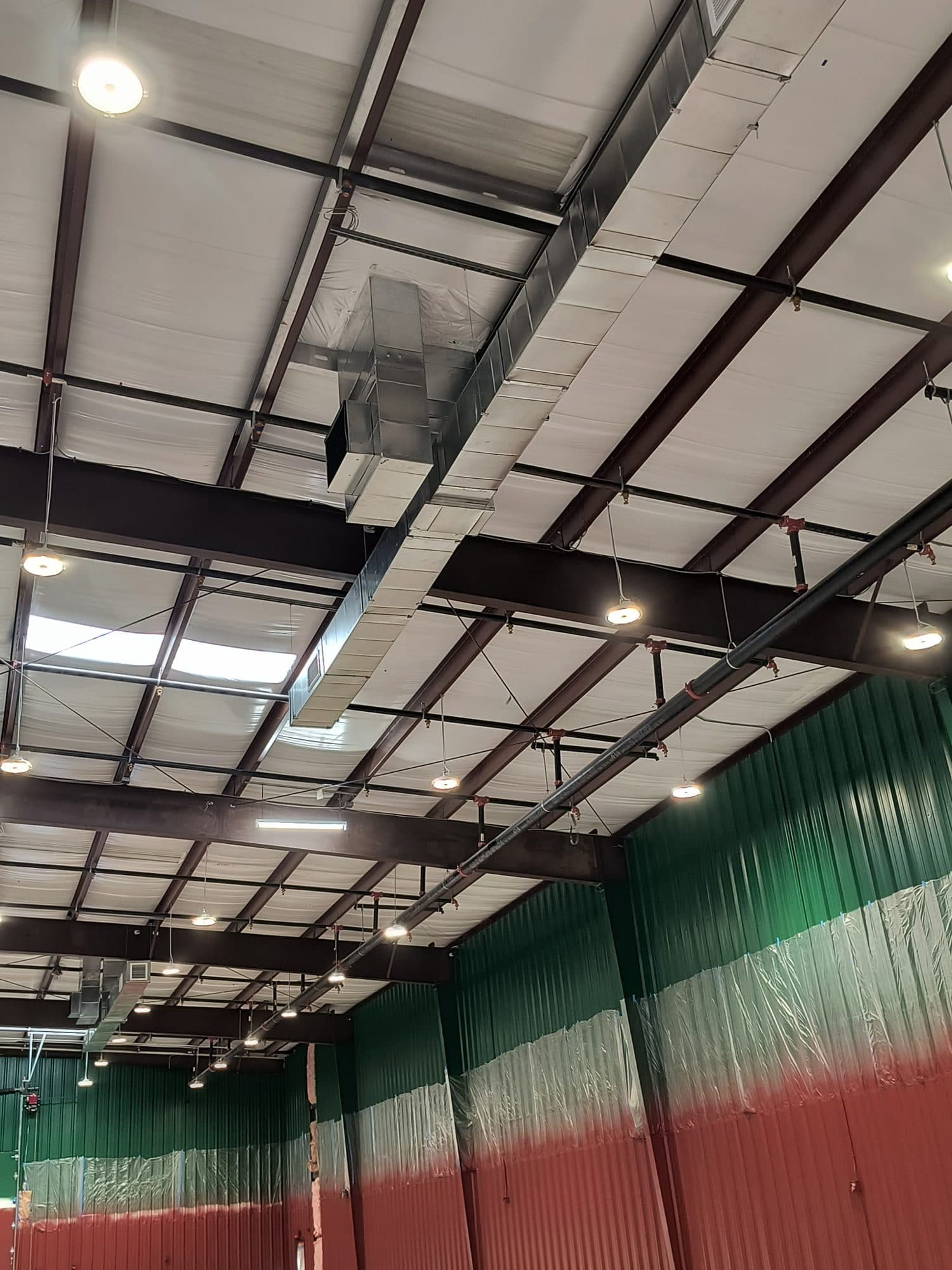 Ductwork routed through open web trusses