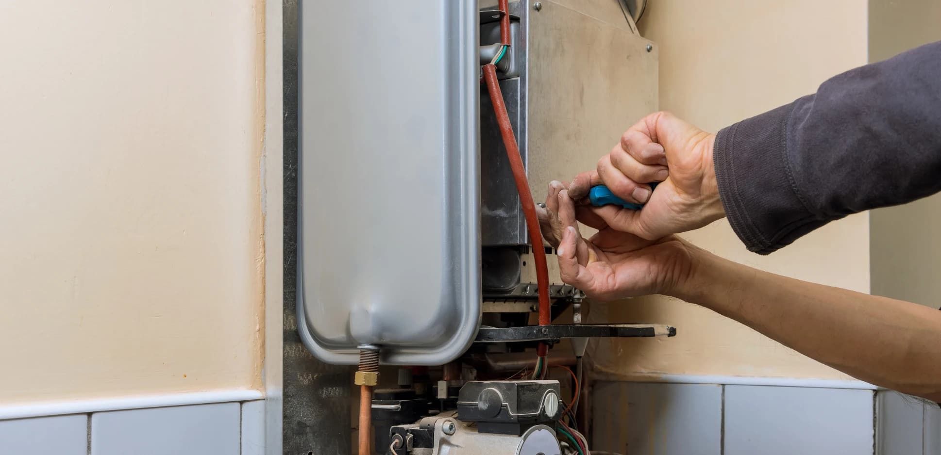 Technician testing a furnace control board during an emergency no-heat call