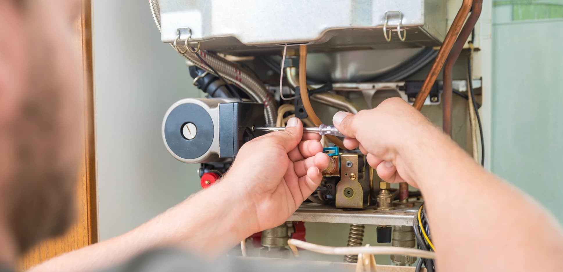 Technician wiring the control board on a newly installed furnace