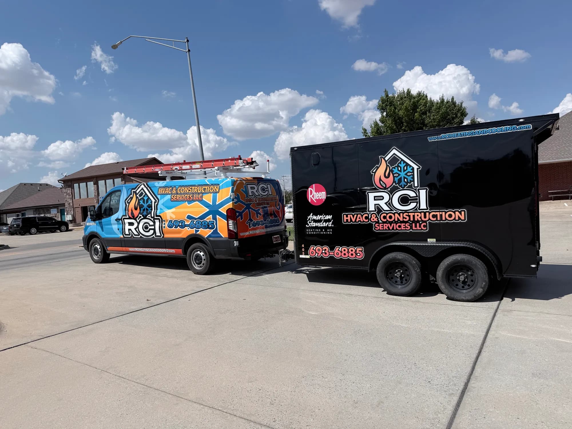 RCI HVAC & Construction Services wrapped service van and enclosed trailer parked under a blue Oklahoma sky