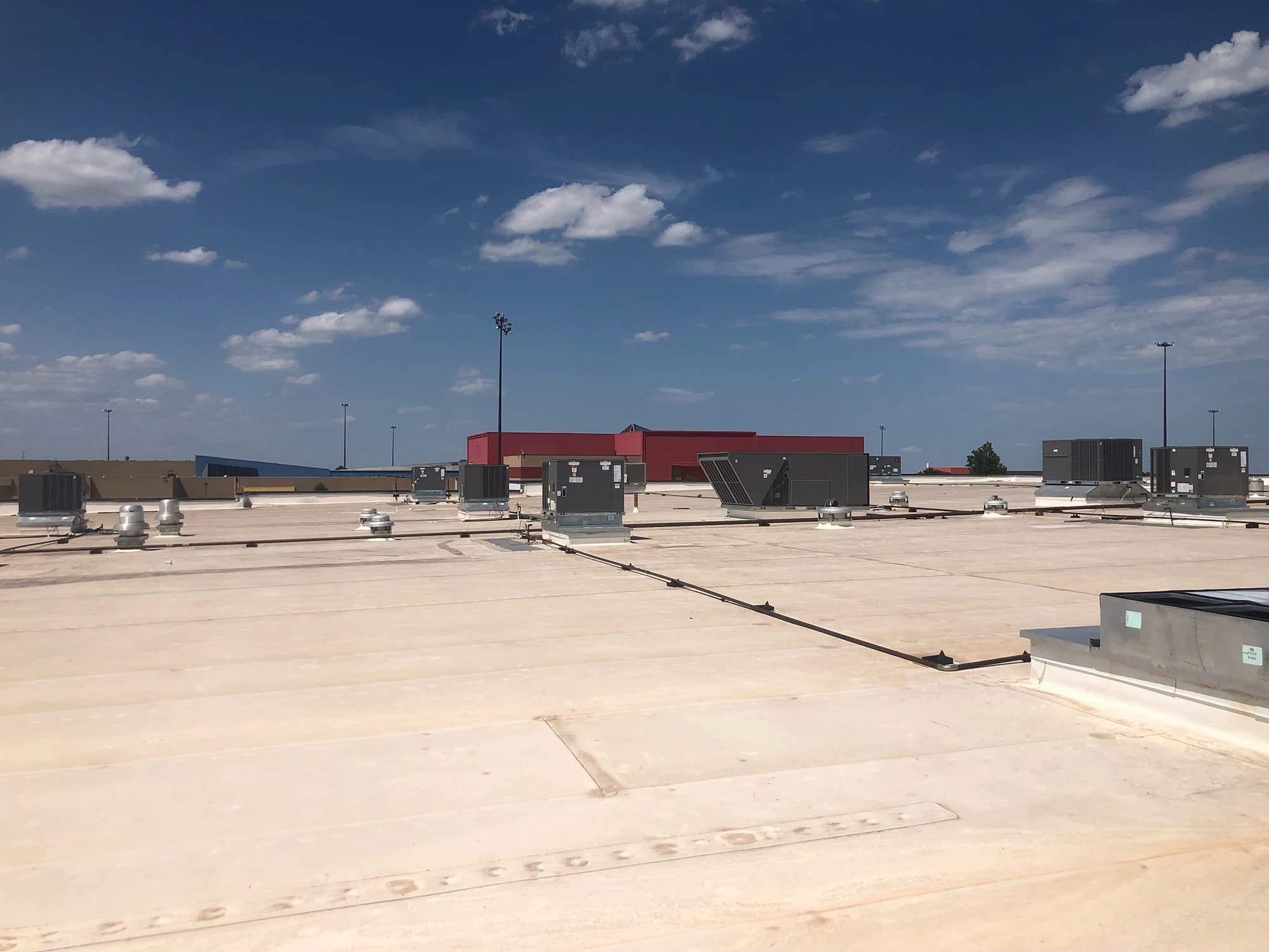 Row of rooftop package units serviced by RCI on an Oklahoma commercial building
