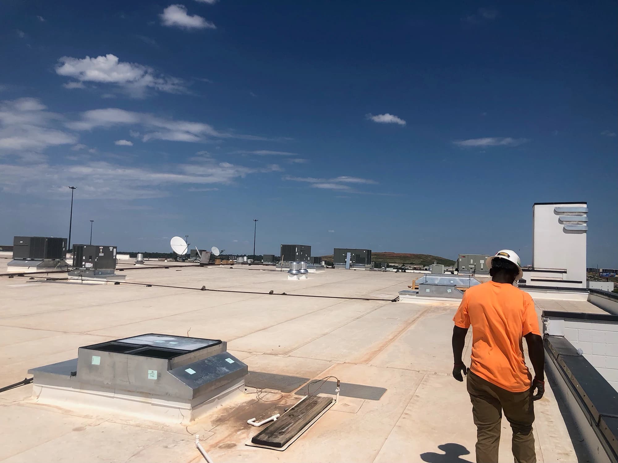 RCI technician servicing rooftop HVAC units